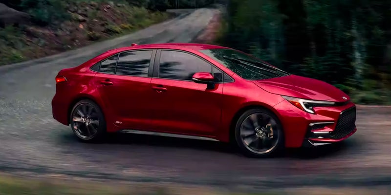A 2024 Toyota Corolla driving down a road near Pleasant Hills, PA
