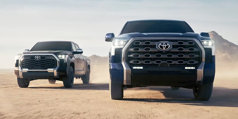 Two 2024 Toyota Tundra trim options driving off-road in Pleasant Hills, PA 