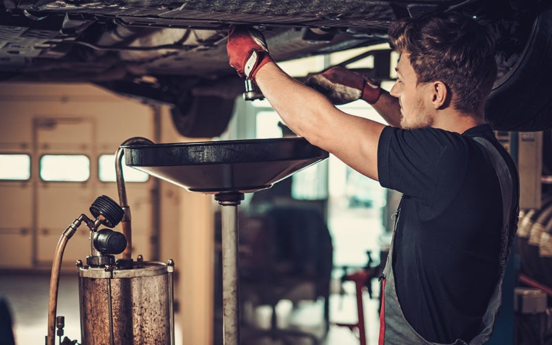 A Toyota service attendant doing a regular oil change in Pleasant Hills, PA.
