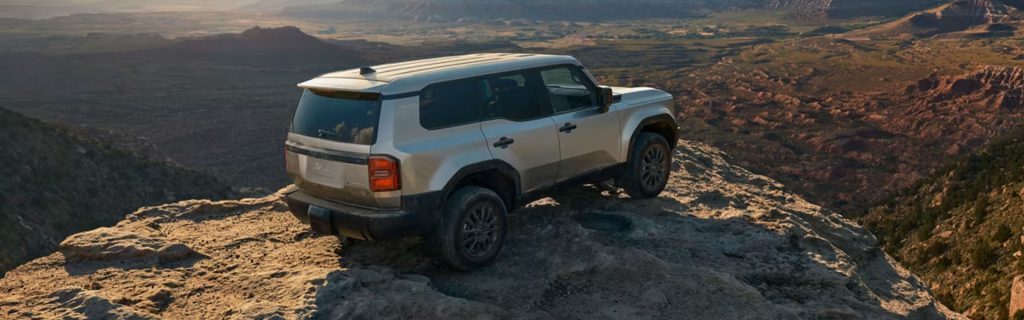 Toyota SUV standing in the cliff of the mountain.