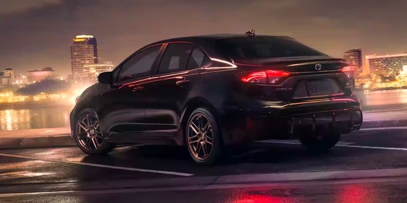 A 2024 Toyota Corolla driving down a highway at night in Pleasant Hills, PA