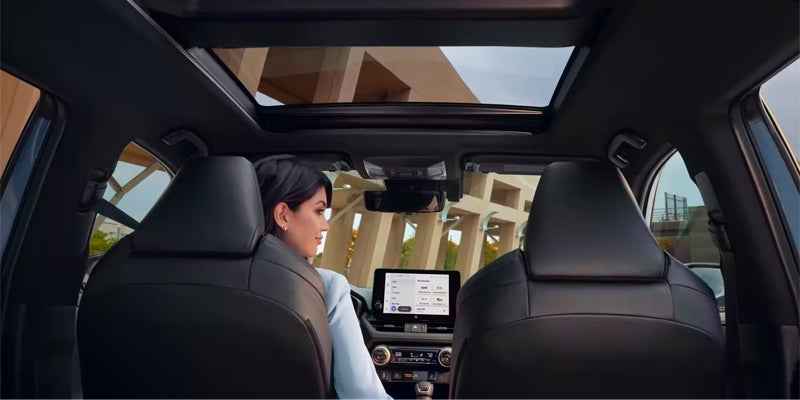 A view from the backseat showcasing the moonroof in the 2024 Toyota RAV4 Hybrid available near Pleasant Hills, PA