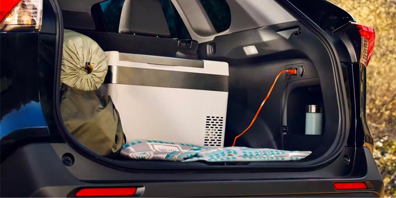 The cargo space and trunk outlet available in the 2024 Toyota RAV4 Hybrid in Pleasant Hills, PA