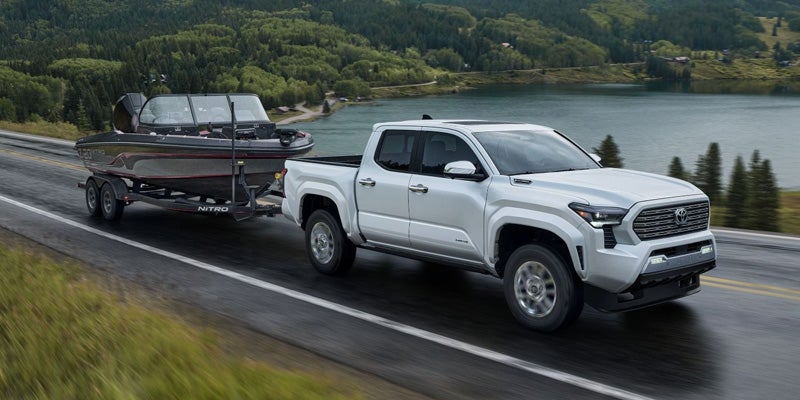 A 2024 Toyota Tacoma in Pleasant Hills, PA towing a boat.