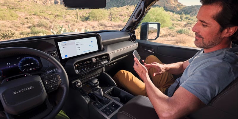 A passenger using wireless connectivity in the 2025 Toyota Land Cruiser in Pleasant Hills, PA